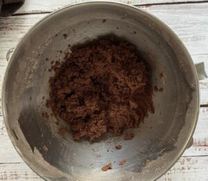 silver bowl with dark brown batter.