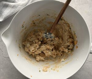 white bowl with cheese ball mixture and a spatula.