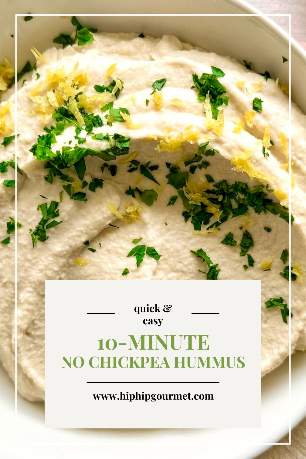 close up of butter bean hummus in a bowl with chopped fresh parsley and lemon zest.