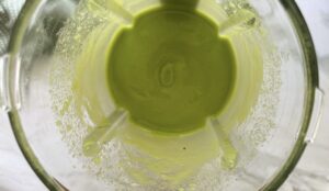 blended green smoothie in a blender.