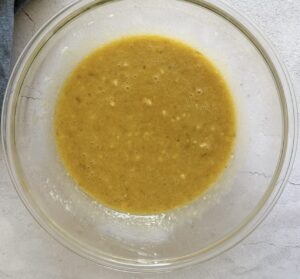 mashed banana batter in a glass bowl.