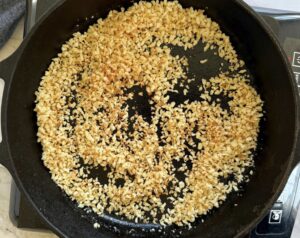 panko breadcrumbs toasting in a cast iron skillet.