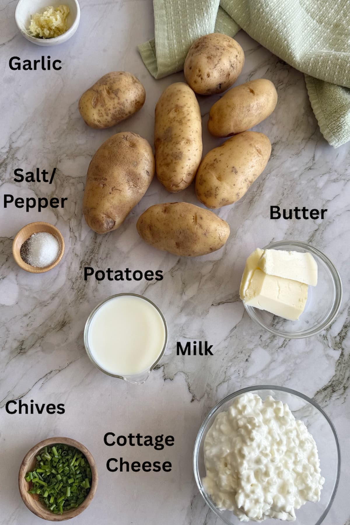ingredients for cottage cheese mashed potatoes - potatoes, garlic, slat/pepper, milk, butter, cottage cheese, and chives.