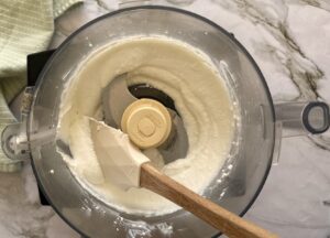 blended smooth cottage cheese in the base of a food processor with a rubber spatula.