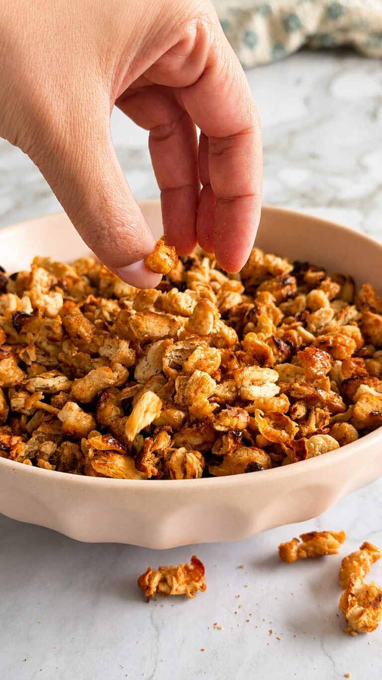 hand grabbing some crispy white beans out of a bowl.