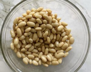 white beans with olive oil in a bowl.