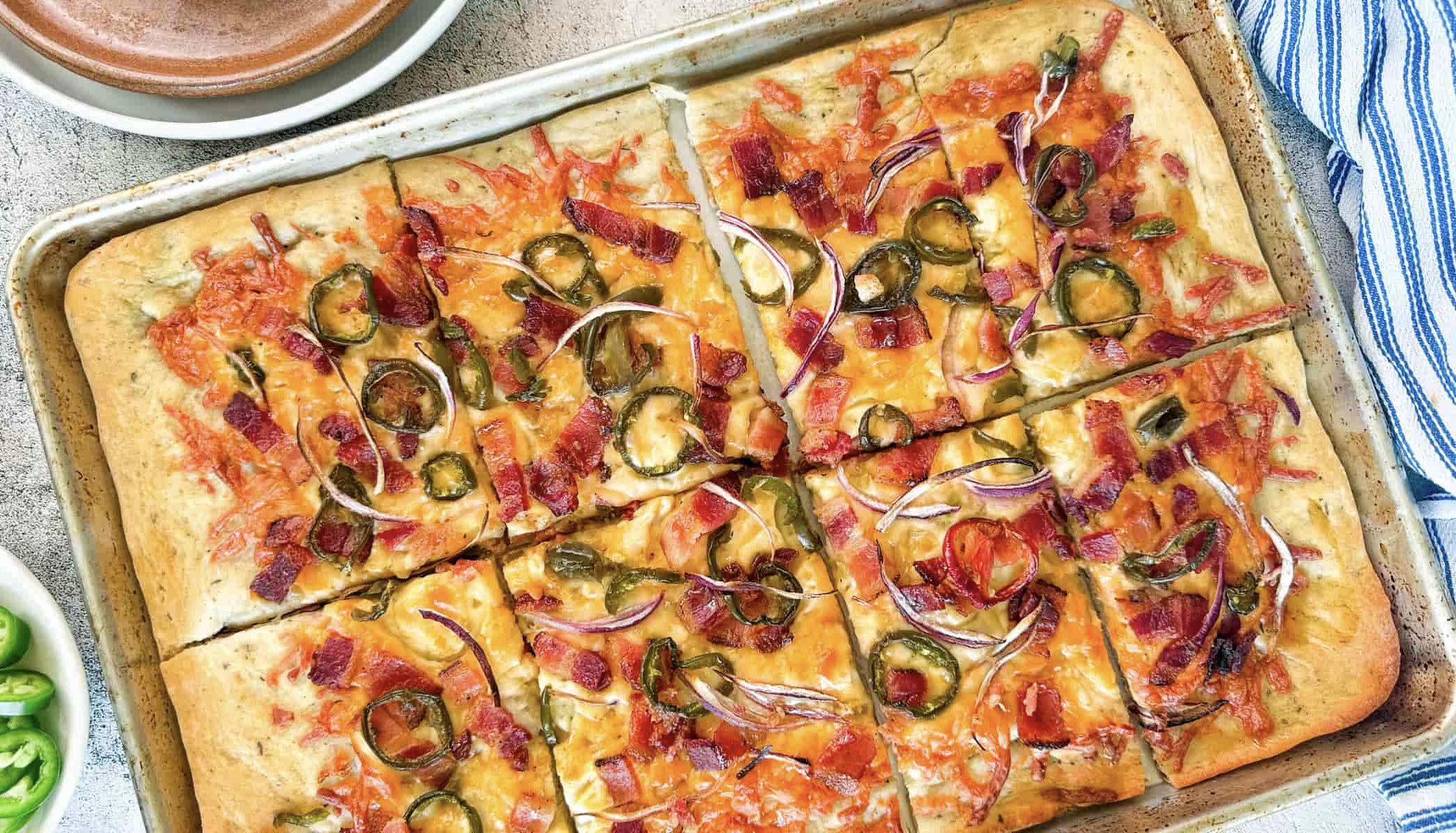 maple bacon jalapeno sheet pan pizza cut into 8 slices.