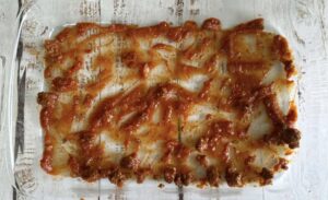 tomato sauce spooned over the bottom of a 9x13 glass baking dish.