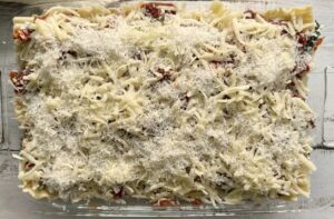 unbaked cheesy lasagna in a 9x13 glass baking dish.