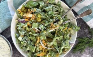 mixed romaine salad with chopped pickles, red onion, cheddar cheese, fresh dill, and a creamy dill pickle ranch dressing.