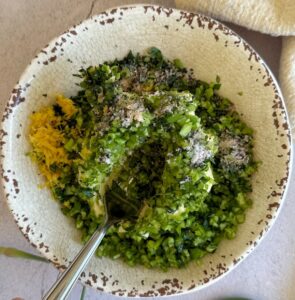 arlic scapes, lemon zest, herbs, and seasonings combined with butter in a rustic bowl before mixing.