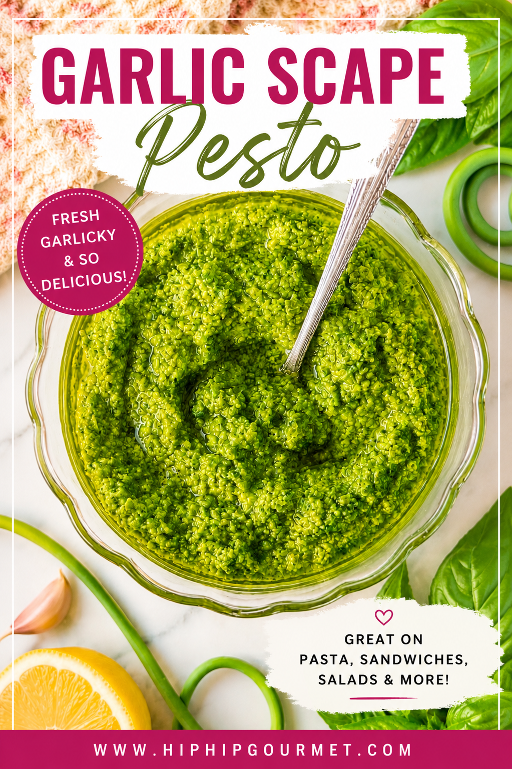 Homemade garlic scape pesto in a glass bowl garnished with olive oil, fresh basil, lemon, and garlic scapes.