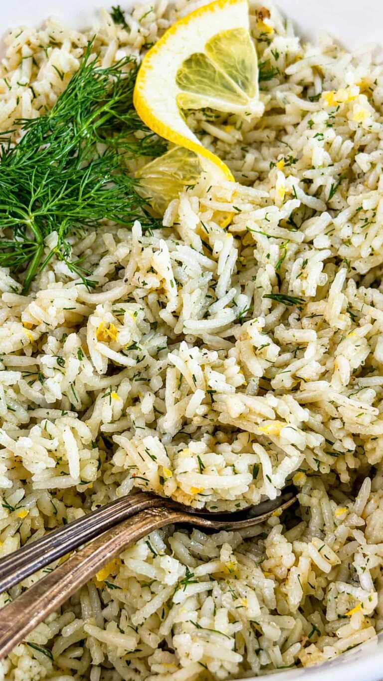 Close up of lemon dill rice with fresh dill, lemon zest, and lemon wedges.