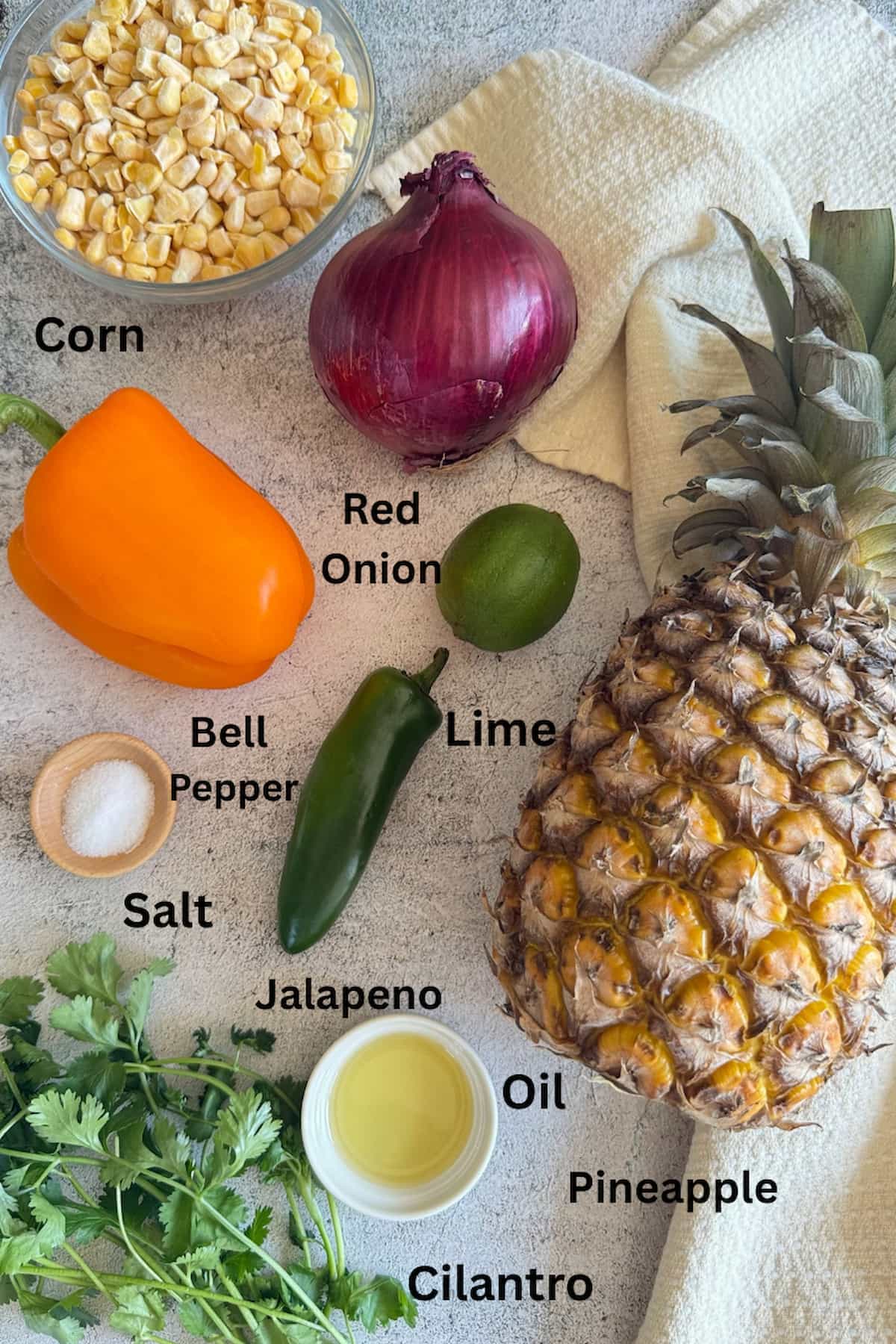 ingredients to make pineapple corn salsa - corn kernels, red onions, lime, jalapeno, bell pepper, pineapple, oil, salt, and cilantro.