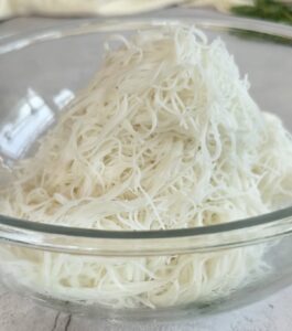 pile of thin rice noodles in a glass bowl.