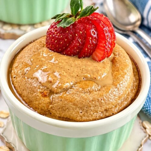 Baked oats without banana topped with creamy peanut butter and fresh strawberries.