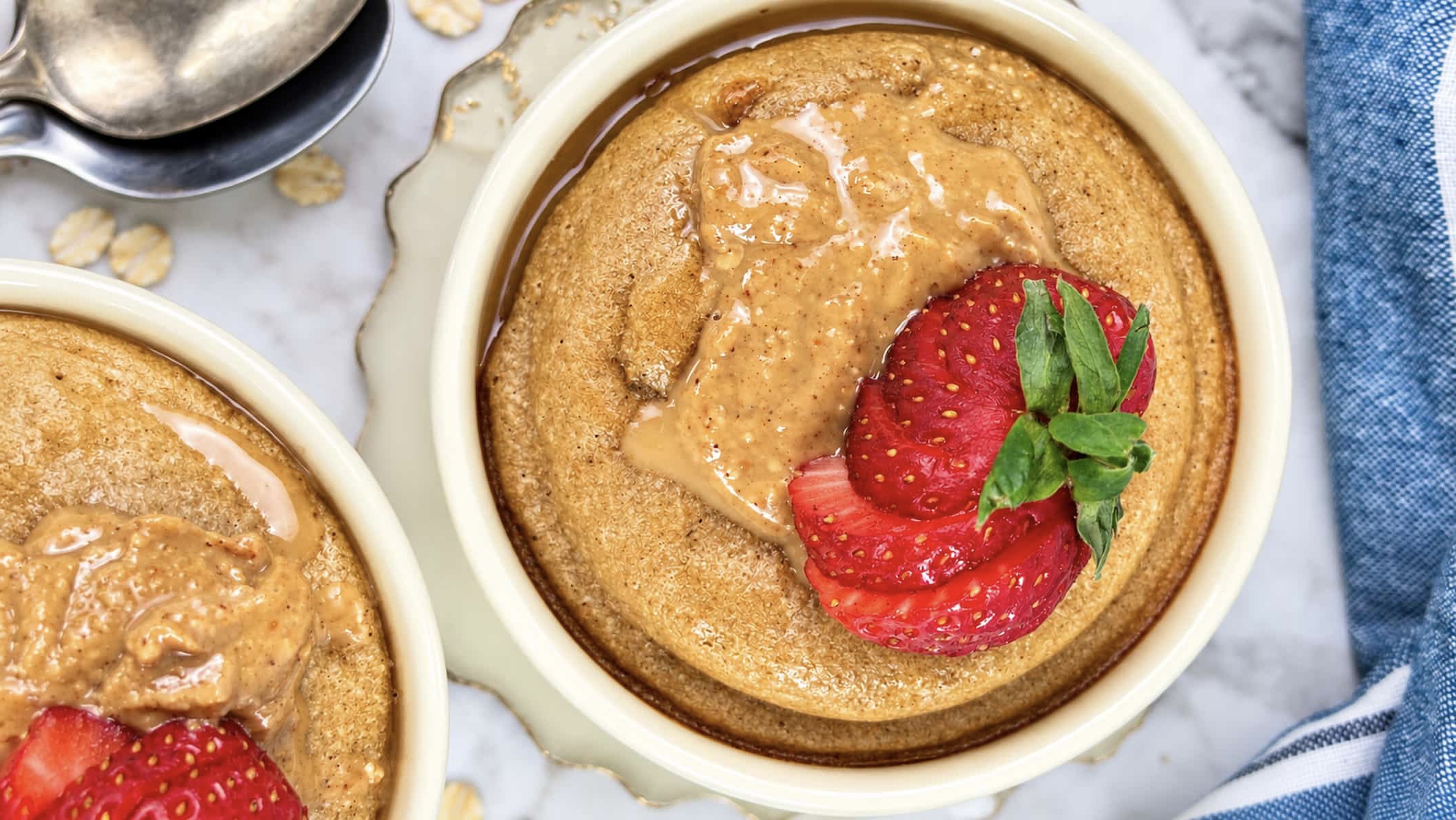 Baked oats without banana topped with creamy peanut butter and fresh strawberries.