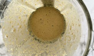 blender with creamy beige liquid.