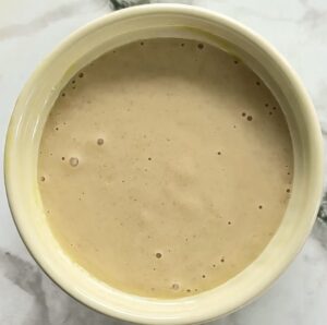 creamy beige batter in a ramekin.