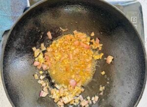 minced garlic and shallots cooked in a cast iron wok.