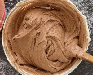 chocolate mousse in a bowl with a rubber spatula.