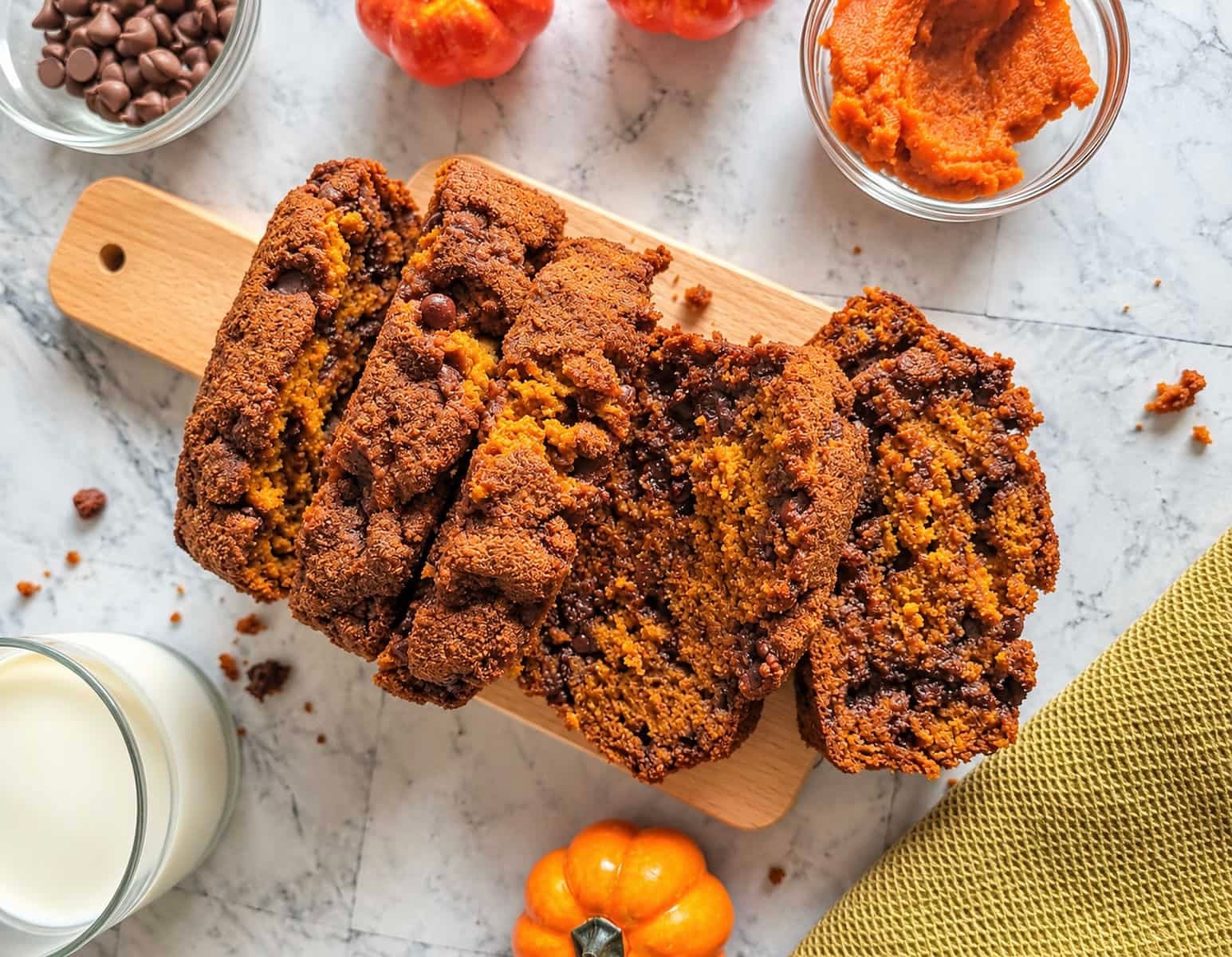 Pumpkin chocolate chip bread slices with a moist pumpkin crumb and melty chocolate chips.