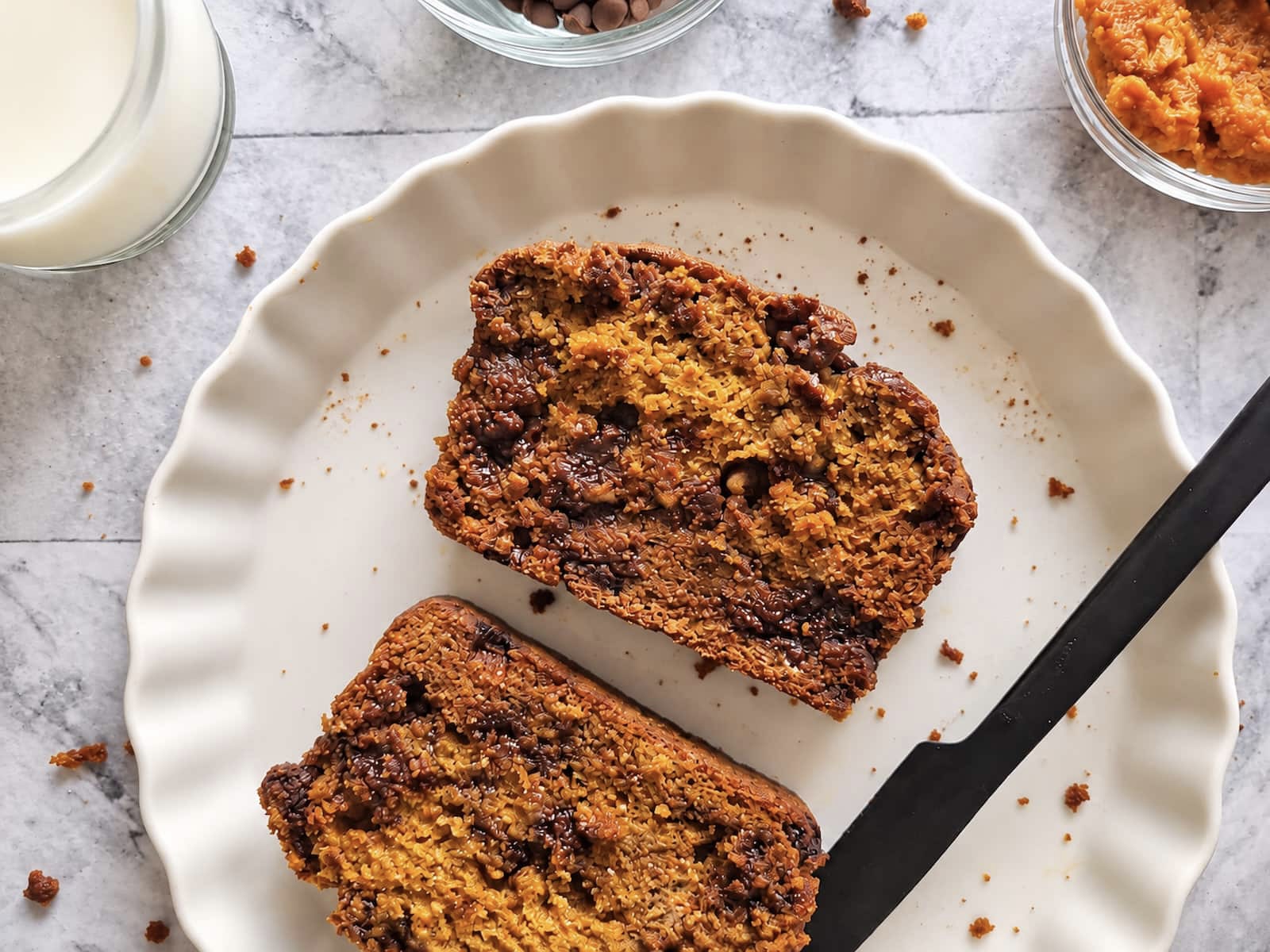 Pumpkin chocolate chip bread slices with a moist pumpkin crumb and melty chocolate chips.