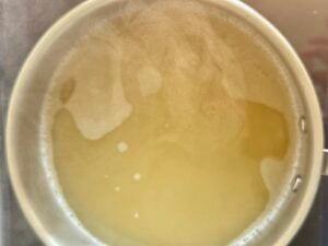 chicken broth steaming in a pot.