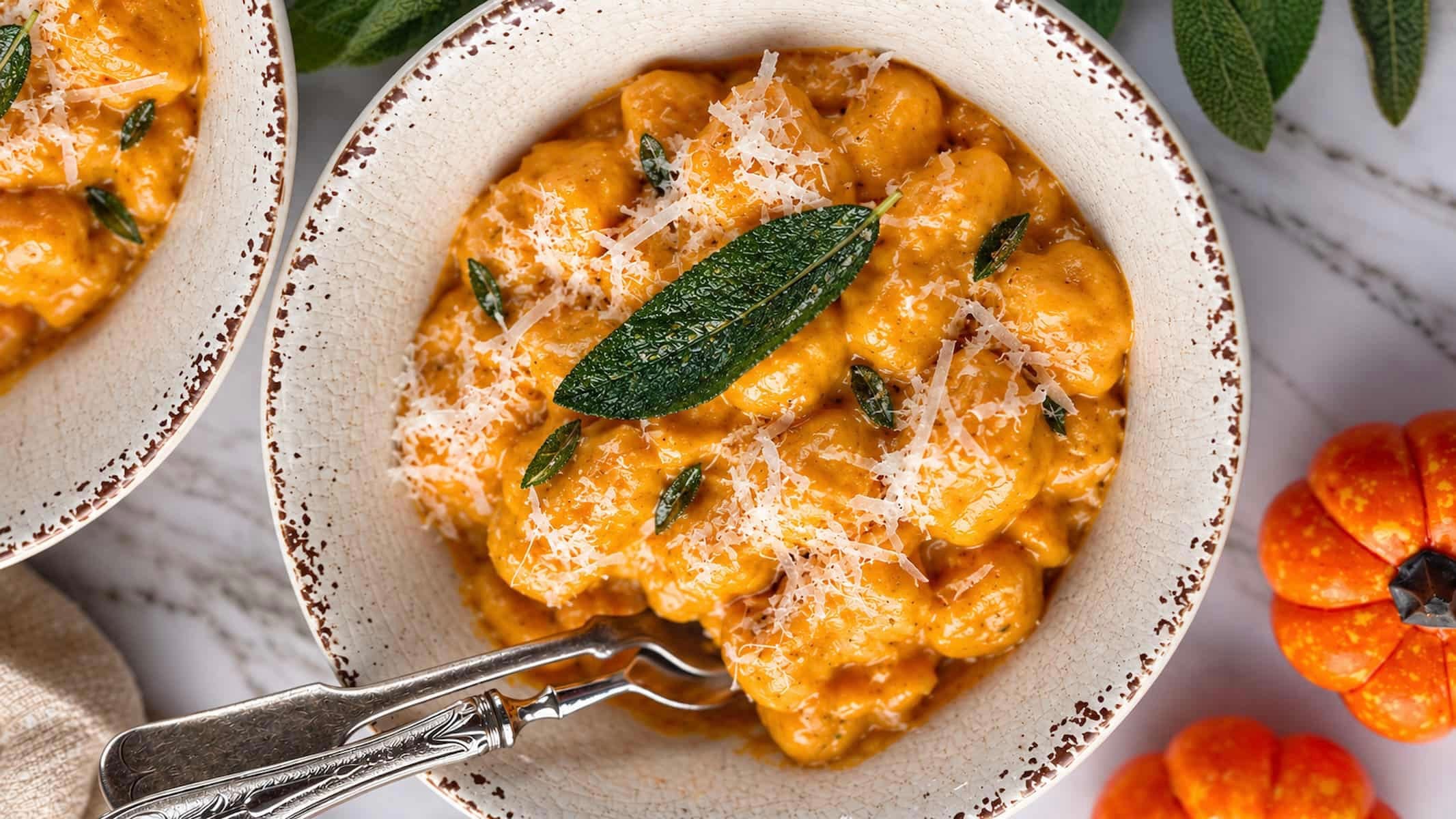 Creamy pumpkin gnocchi in a rich pumpkin sauce, topped with freshly grated Parmesan cheese and crispy sage.