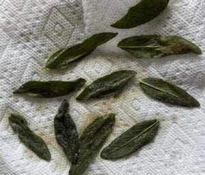 fried sage leaves on a piece of paper towel.