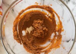 pumpkin filling mixture in a glass bowl for pumpkin pie tarts.